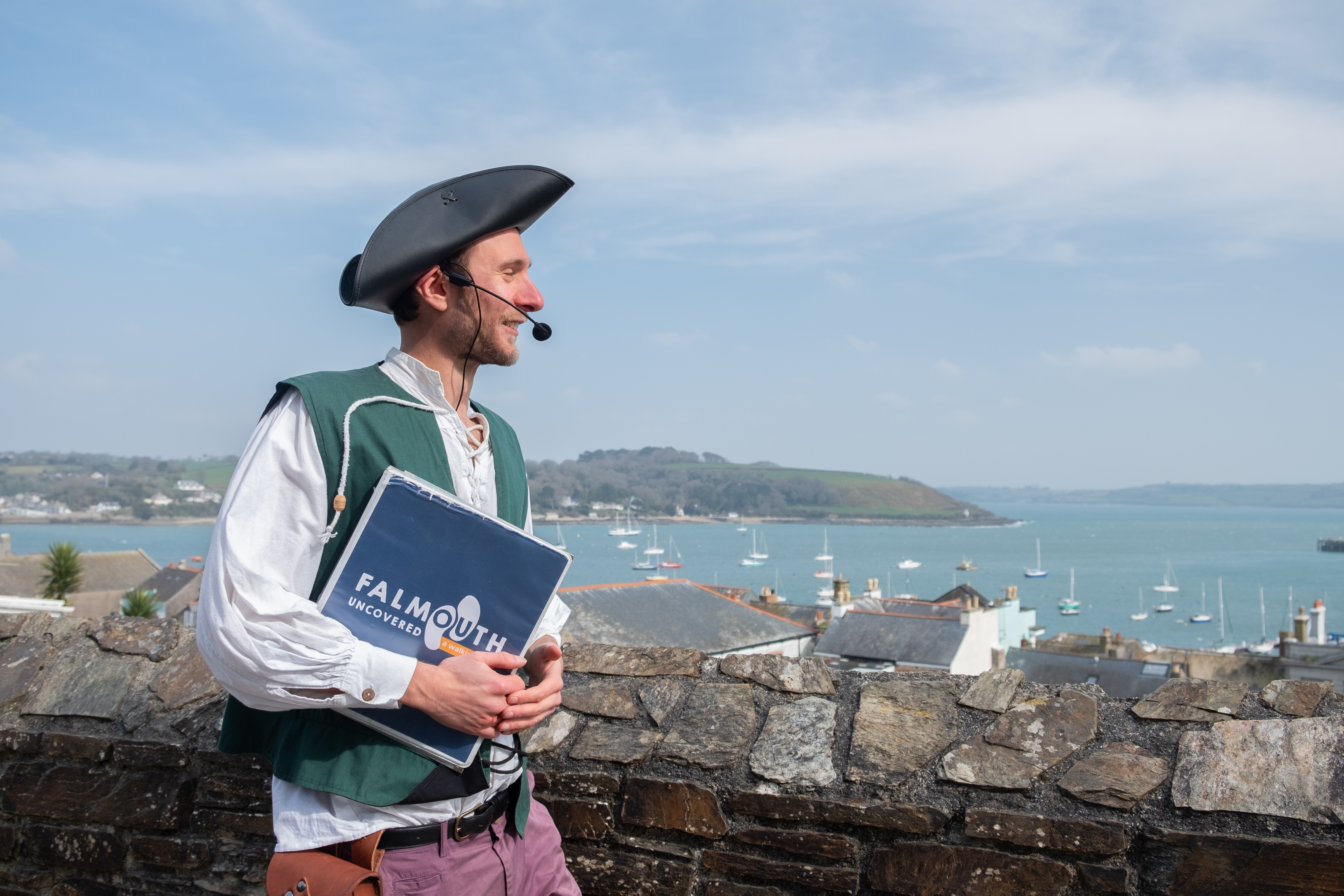 Will Hazell telling Falmouth true stories against backdrop of Fal estauary.