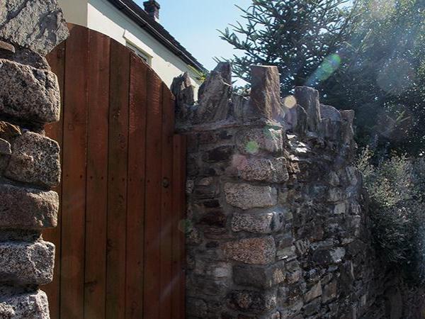 Stone wall and wooden gateway in Liskeard