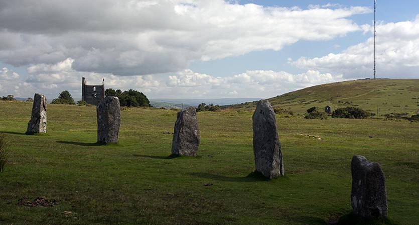 Part of The Hurlers stone circle with Phoenix Mine and Caradon Hill in the background